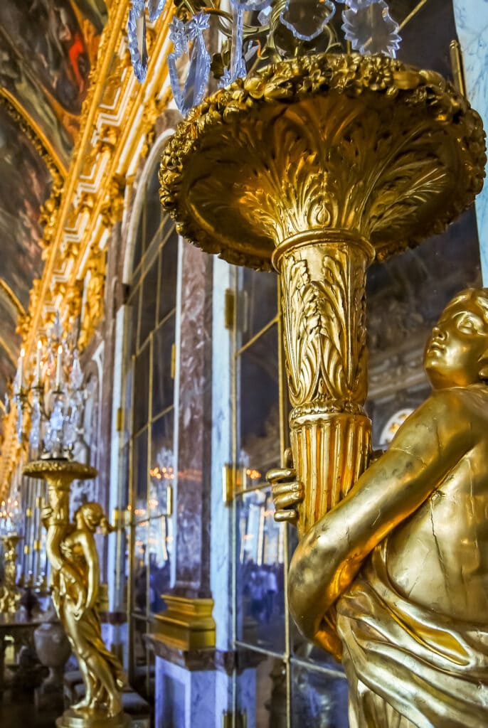 Gold statues in the Hall of Mirrors at Versailles