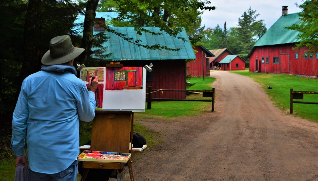 One of the Adirondack Plein Air members paints the staff buildings of the Upper Complex