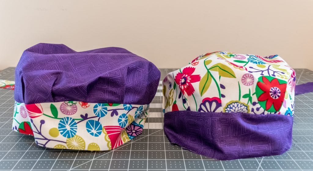 Two finished reversible scrub caps