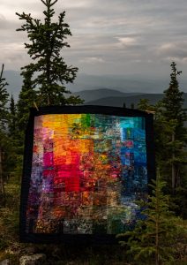 a rainbow quilt inspired by the midnight sun