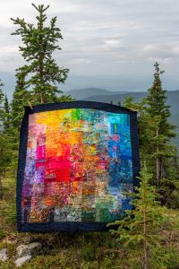 a rainbow quilt inspired by the midnight sun