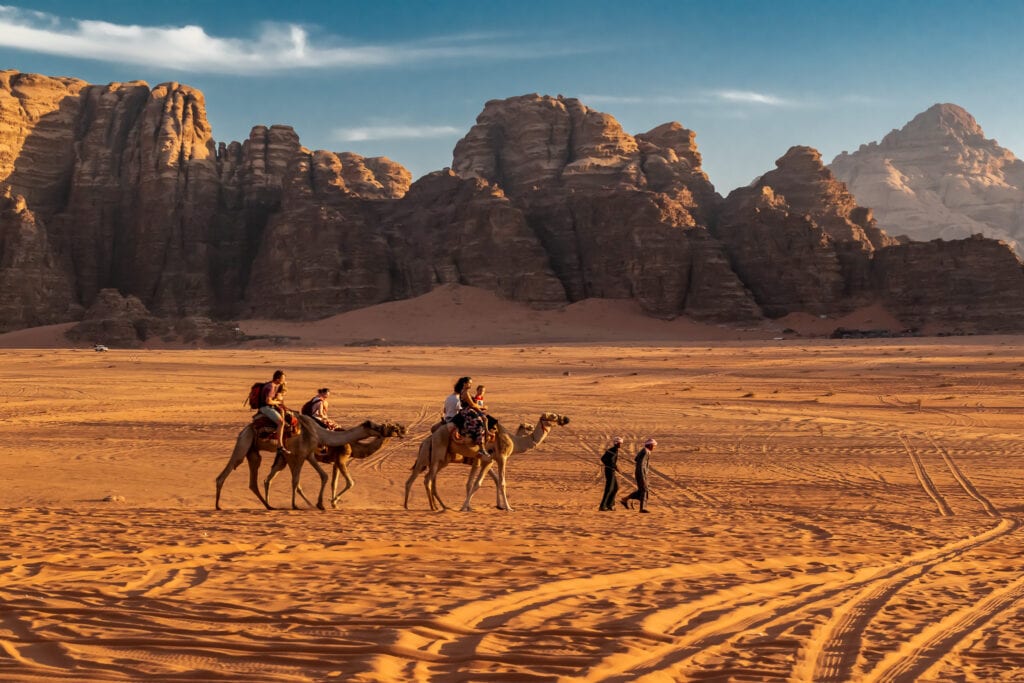 Riding camels toward the sunset