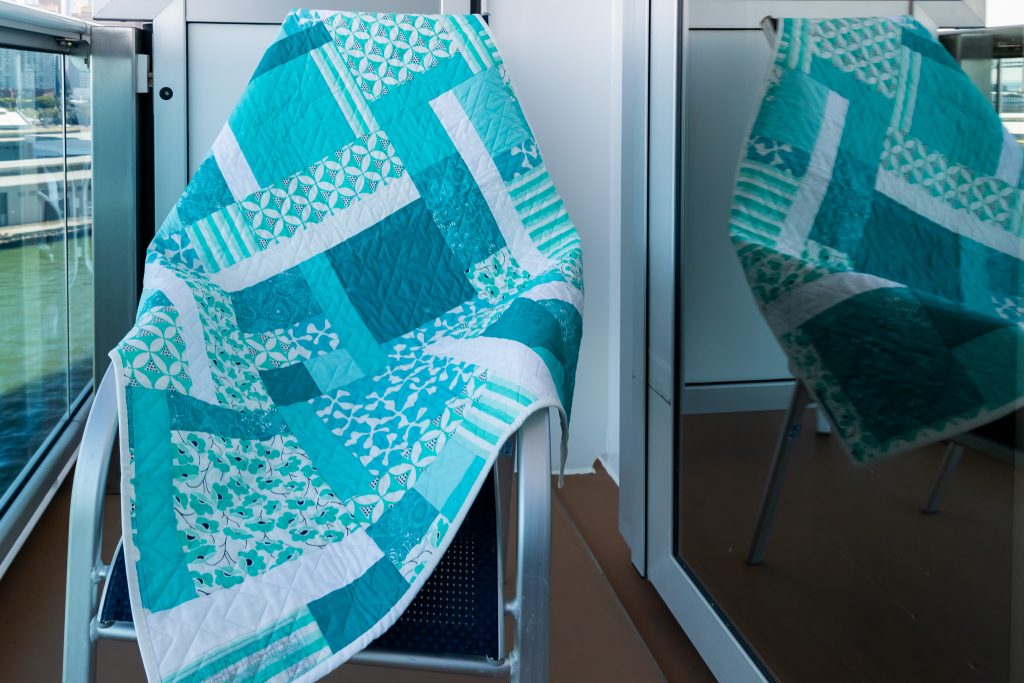 Back of a quilt using a "turning 20" pattern