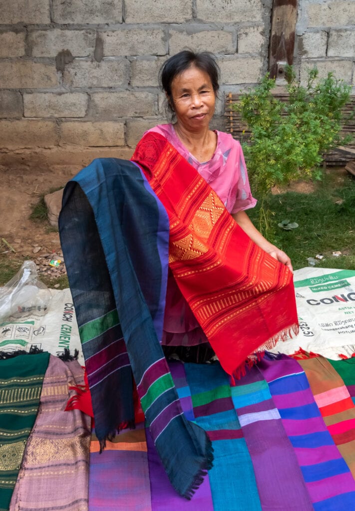 women in Laos selling their handmade scarves