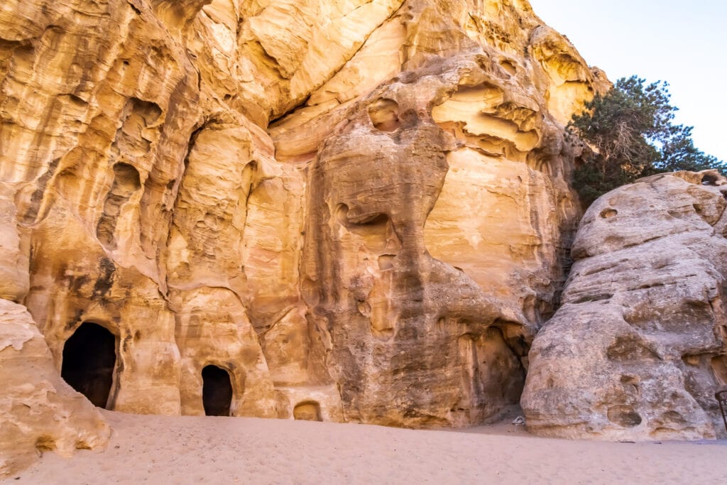 caves in the rock face at Little Petra
