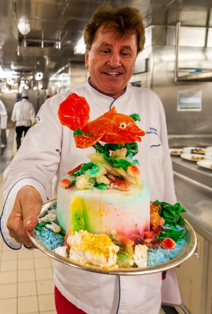 Chef Rudi shows off one of the elaborate cake creations