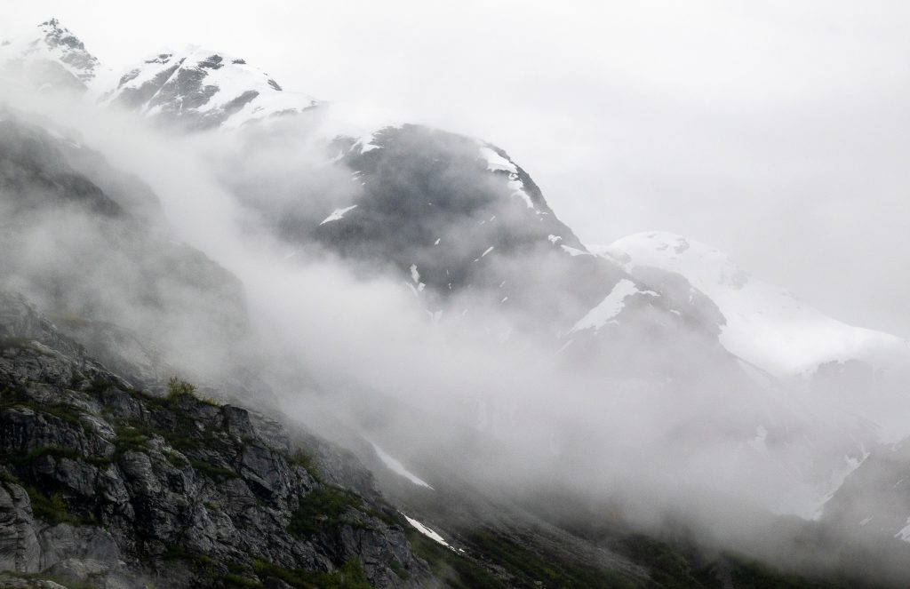 Mountains in Glacier Bay shrouded in fog -