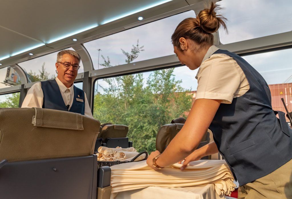 Onboard hosts Mike and Olivia prepare our seat side tables with crisp table linens