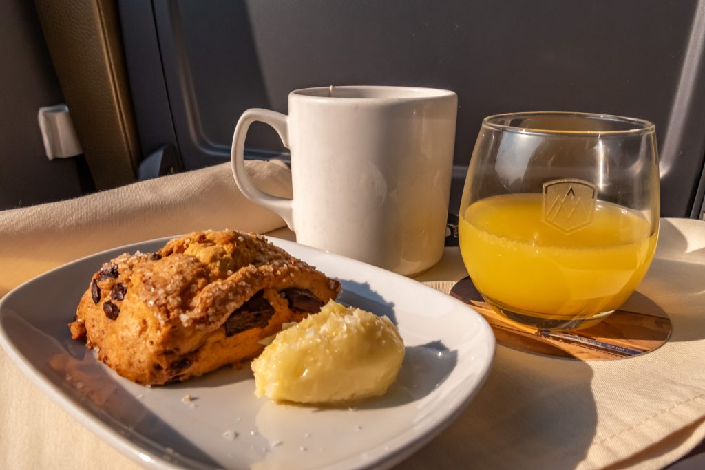 A warm scone, honey butter and an cup of hot tea
