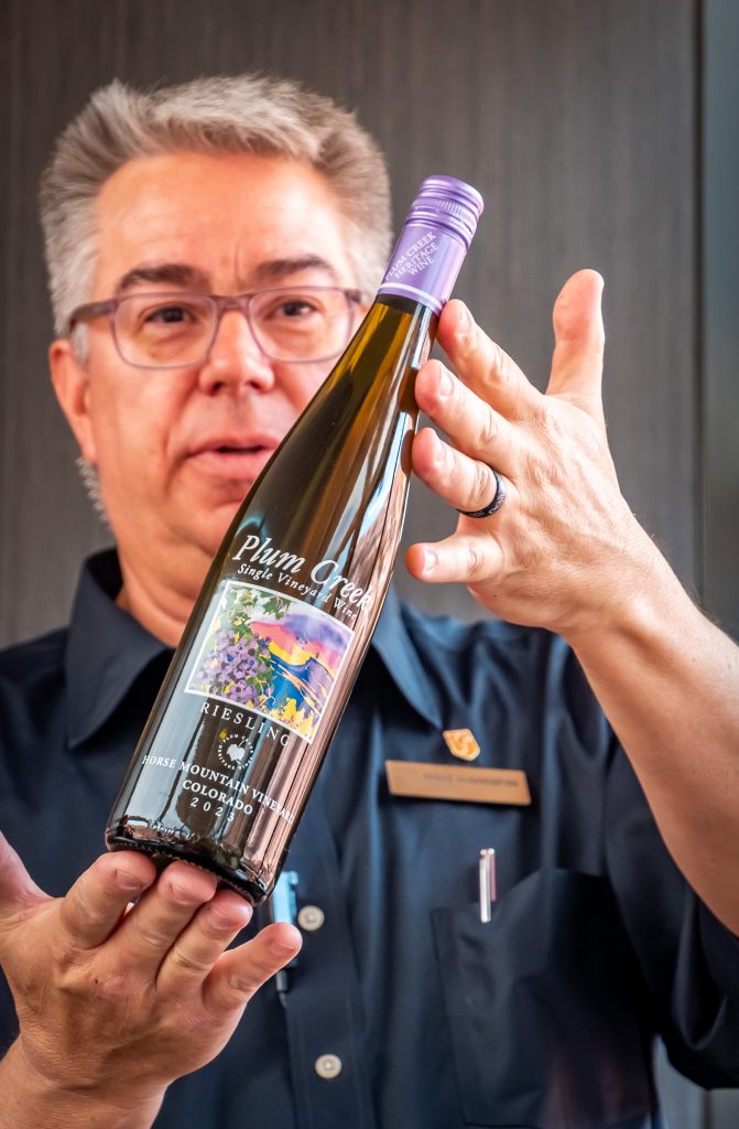 Host Michael shows off the recommended wine pairing - a crisp Plum Creek riesling