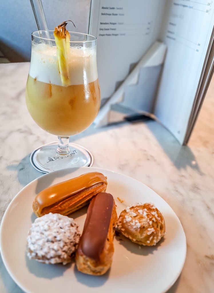 Choux pastries and a tropical cocktail at afternoon tea