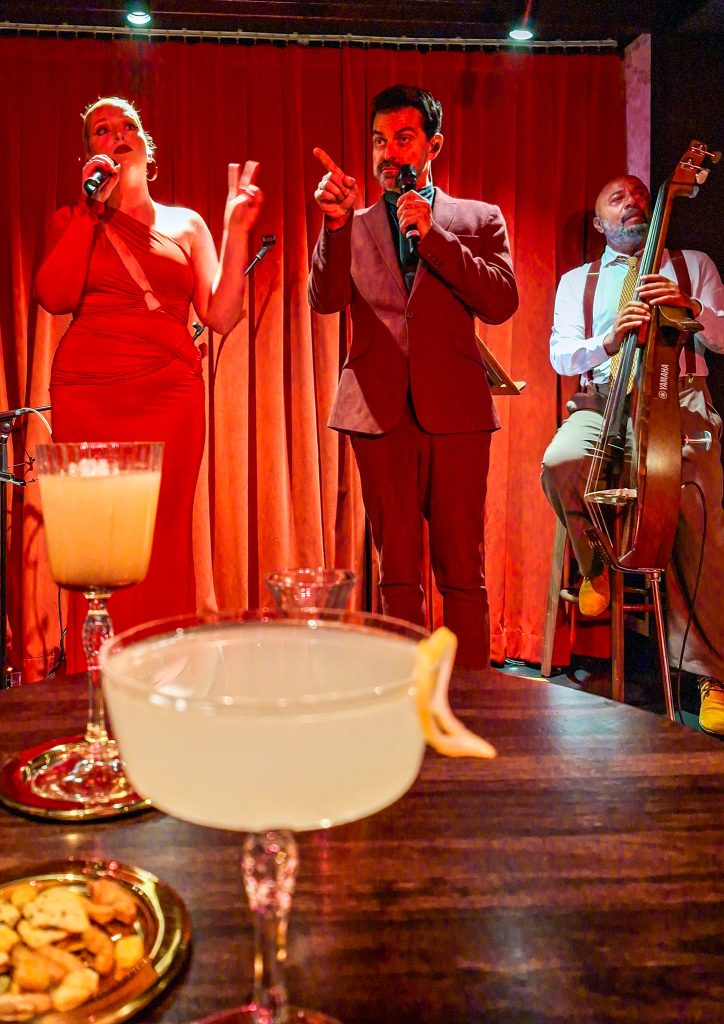 Jazz singers and trio performing in the speakeasy